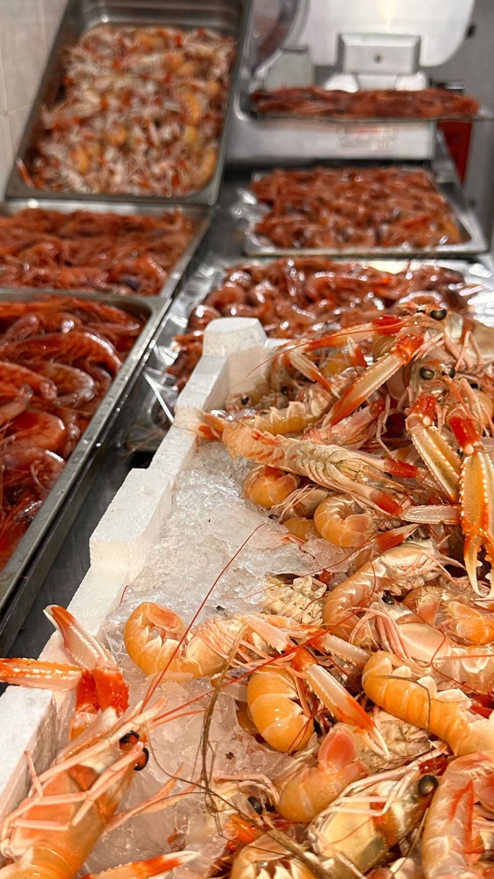 Gamberi e scampi freschi sul ghiaccio al banco